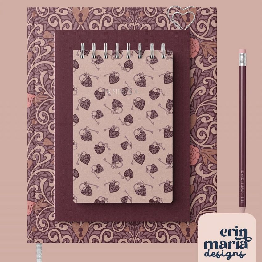 Stationery set mockup featuring a spiral notebook with a heart and key pattern on top of a larger patterned folder, with a pencil and a logo card.