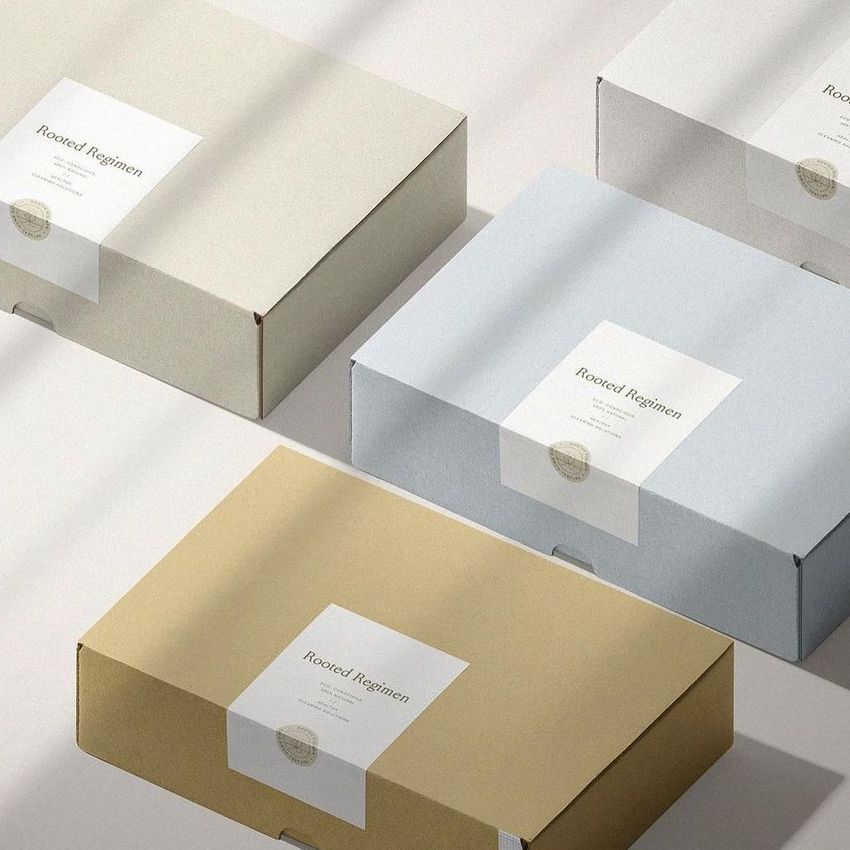 Mailing boxes mockup arranged in a diagonal layout, featuring beige, gray, and light brown boxes with stickers on a light surface.