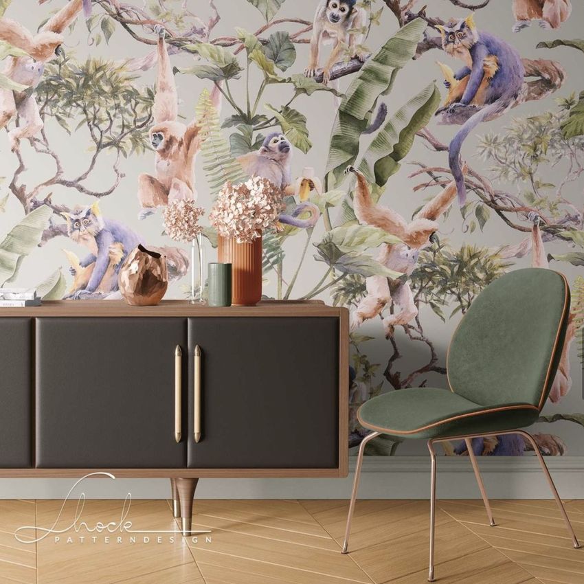 Canvas print mockup showing a sideboard with glass vases and dried flowers, green chair, and wallpaper with monkeys and trees.