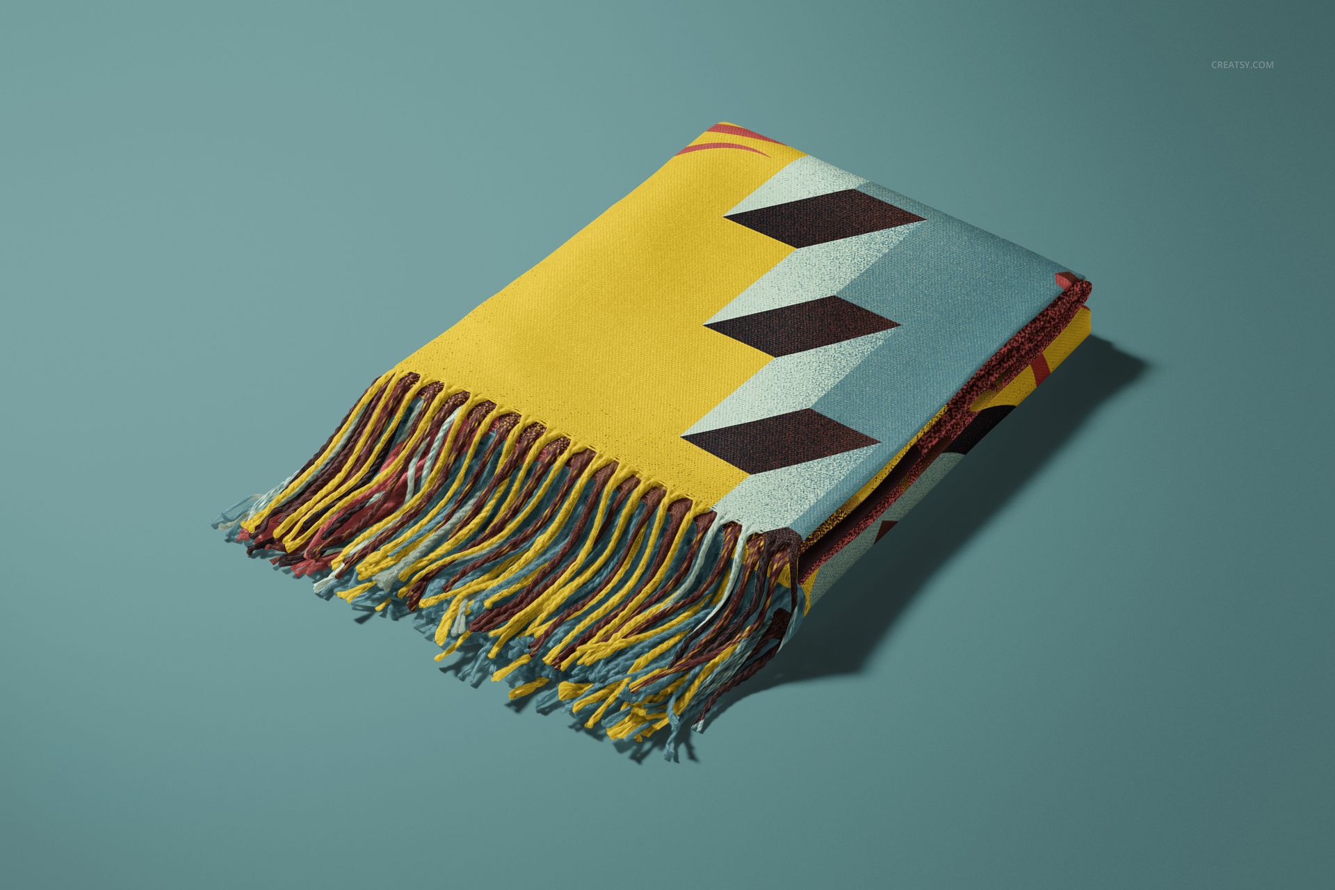 Colorful blanket mockup with fringed edges, displaying bold zigzag design in yellow, blue, and black tones.