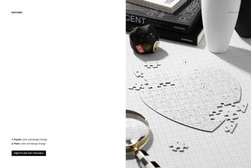 Heart jigsaw puzzle mockup on a modern desk with scattered pieces, books, a black lucky cat figurine, and a magnifying glass.