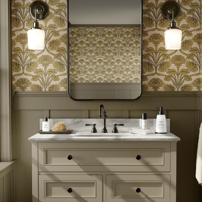 Bathroom mockup showing a beige vanity with a marble countertop, decorative bottles, and a floral wallpaper background.