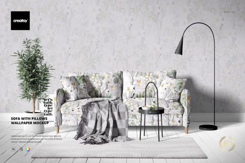 PSD mockup showing a sofa with matching pillows, floral wallpaper background, and decorative props in a living room.