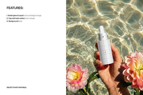 Hand holding a dropper bottle mockup in clear water with ripples, reflections, and pink flowers nearby.