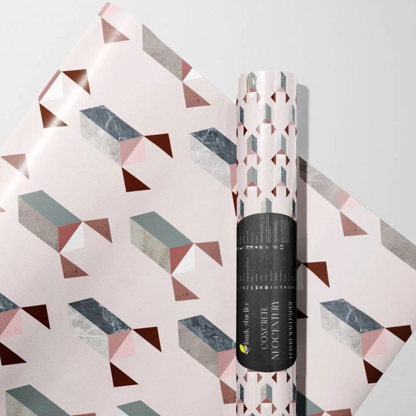 Gift wrapping paper mockup showing a rolled sheet and a flat sheet with geometric patterns in pink, gray, and brown tones.