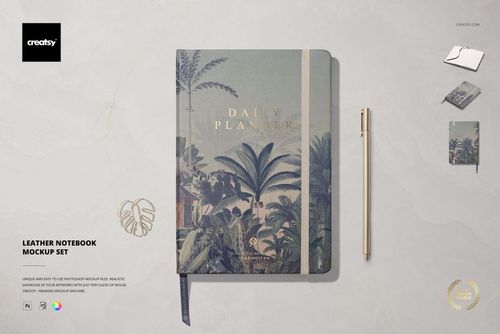 Leather notebook mockup with botanical design, hardcover, ribbon bookmark, and matching pen on a light surface.