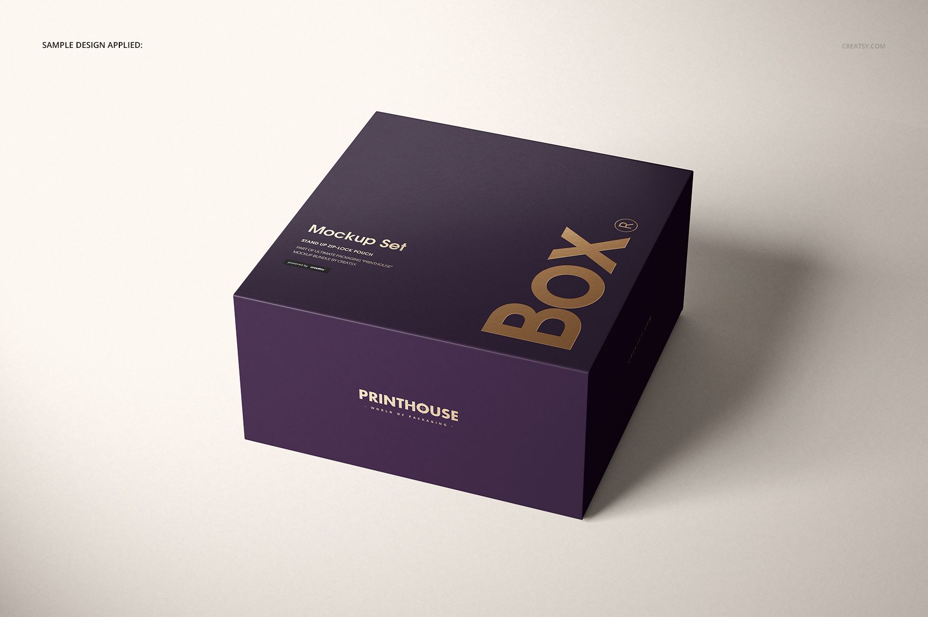 Magnetic gift box mockup in deep purple with gold lettering, displayed in perspective view with soft shadows.