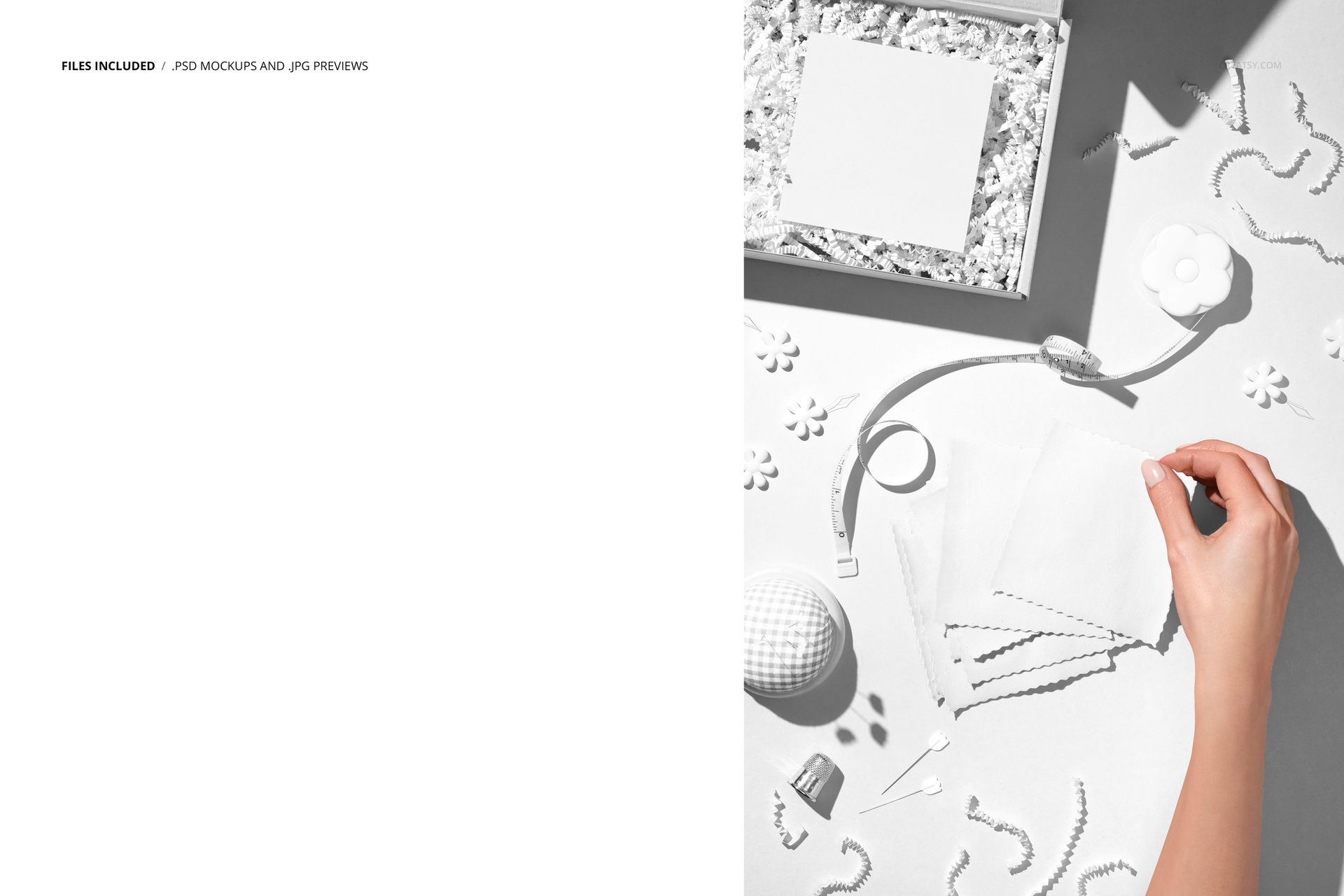 PSD mockup showing jersey fabric samples, a hand, box with shredded paper, and sewing tools arranged on a light surface.