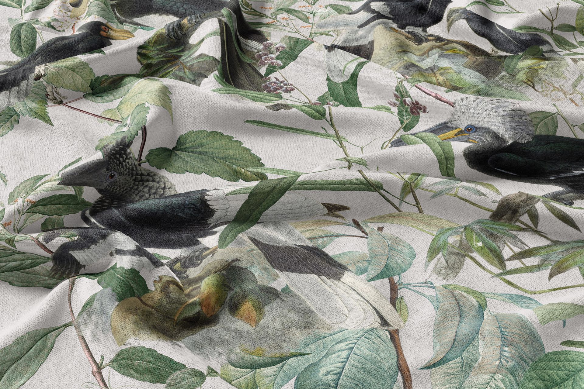 Curtains and upholstery fabric mockup featuring a nature-inspired design with birds and green leaves in a draped arrangement.