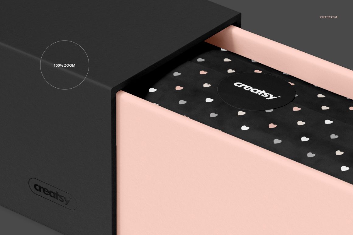 Front view of a rectangular gift box mockup with a pink outer sleeve and black inner wrapping featuring white heart patterns.