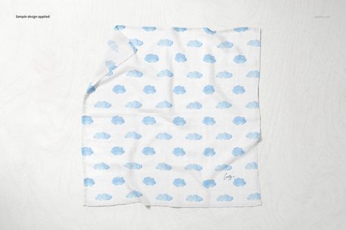 Baby muslin square nappy mockup featuring a soft white fabric with blue clouds, shown from above on a pale background.