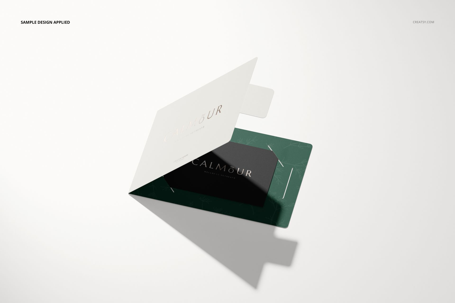 Gift card holder mockup featuring a white card and green holder with gold text, displayed on a light background.