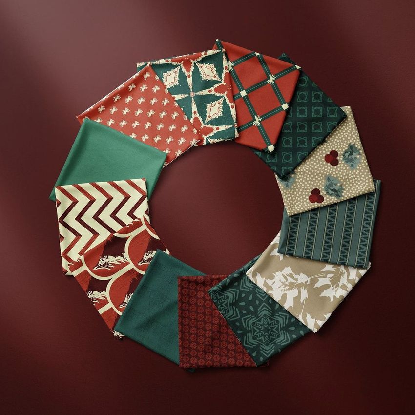 Folded fabrics mockup featuring a circular arrangement of patterned textile samples in red, green, and beige on a dark maroon background.