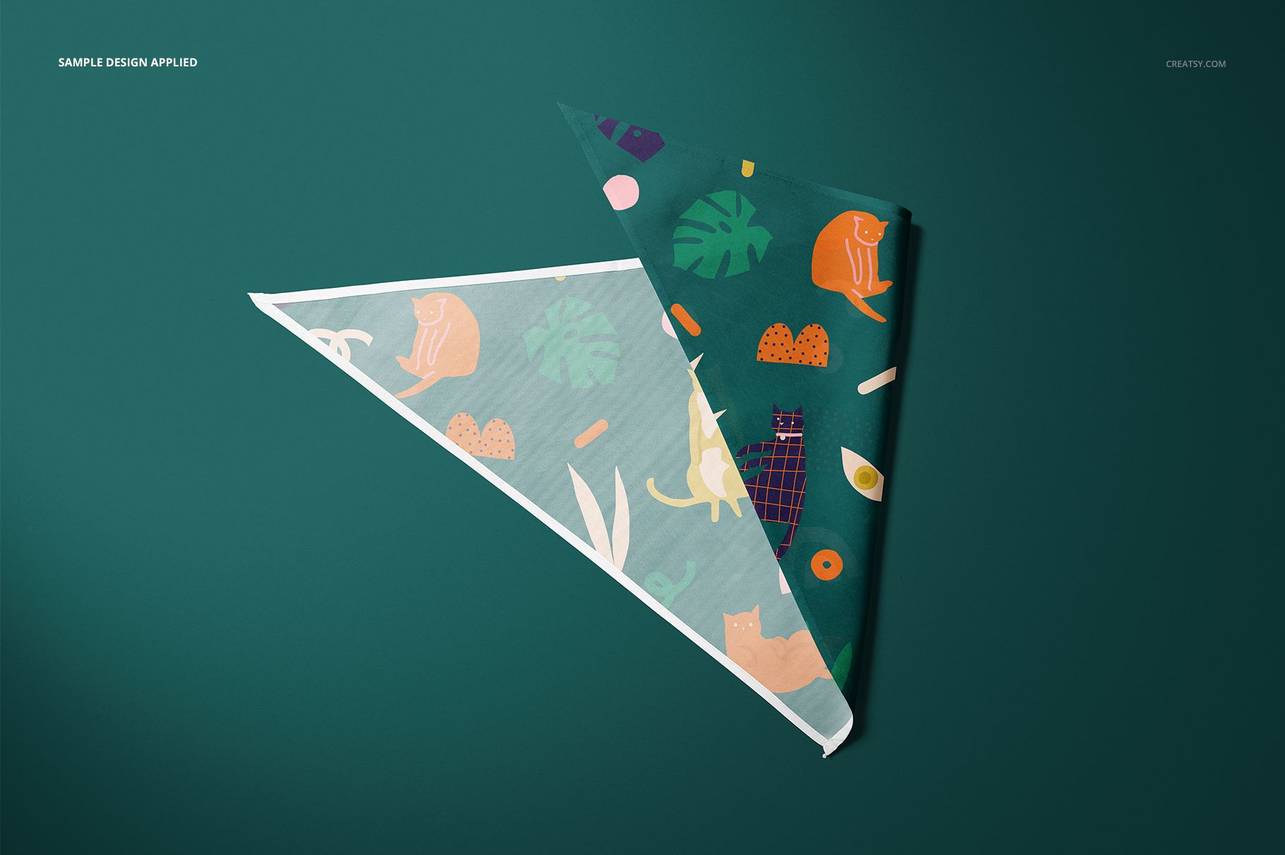 Pet bandana mockup set showing two folded bandanas with colorful cat motifs and botanical designs on a green background.