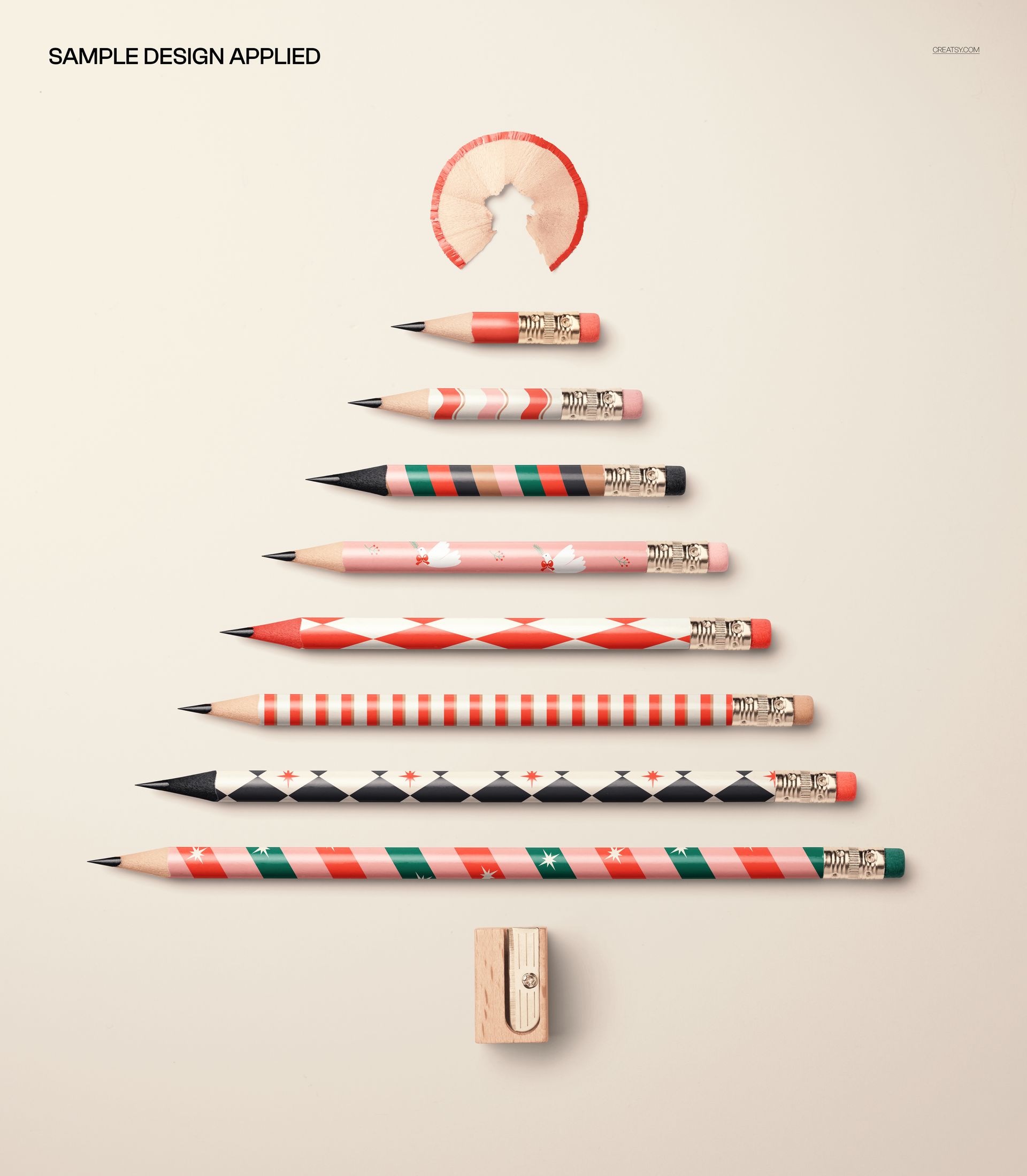 PSD mockup featuring pencils of various sizes and holiday patterns forming a Christmas tree, set against a neutral surface.