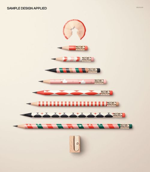 PSD mockup featuring pencils of various sizes and holiday patterns forming a Christmas tree, set against a neutral surface.
