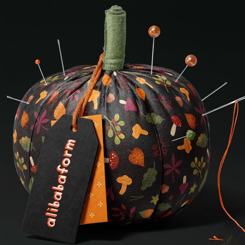 Fabric pumpkin mockup with a dark background, decorated with colorful autumn leaves and mushrooms, used as a pincushion.