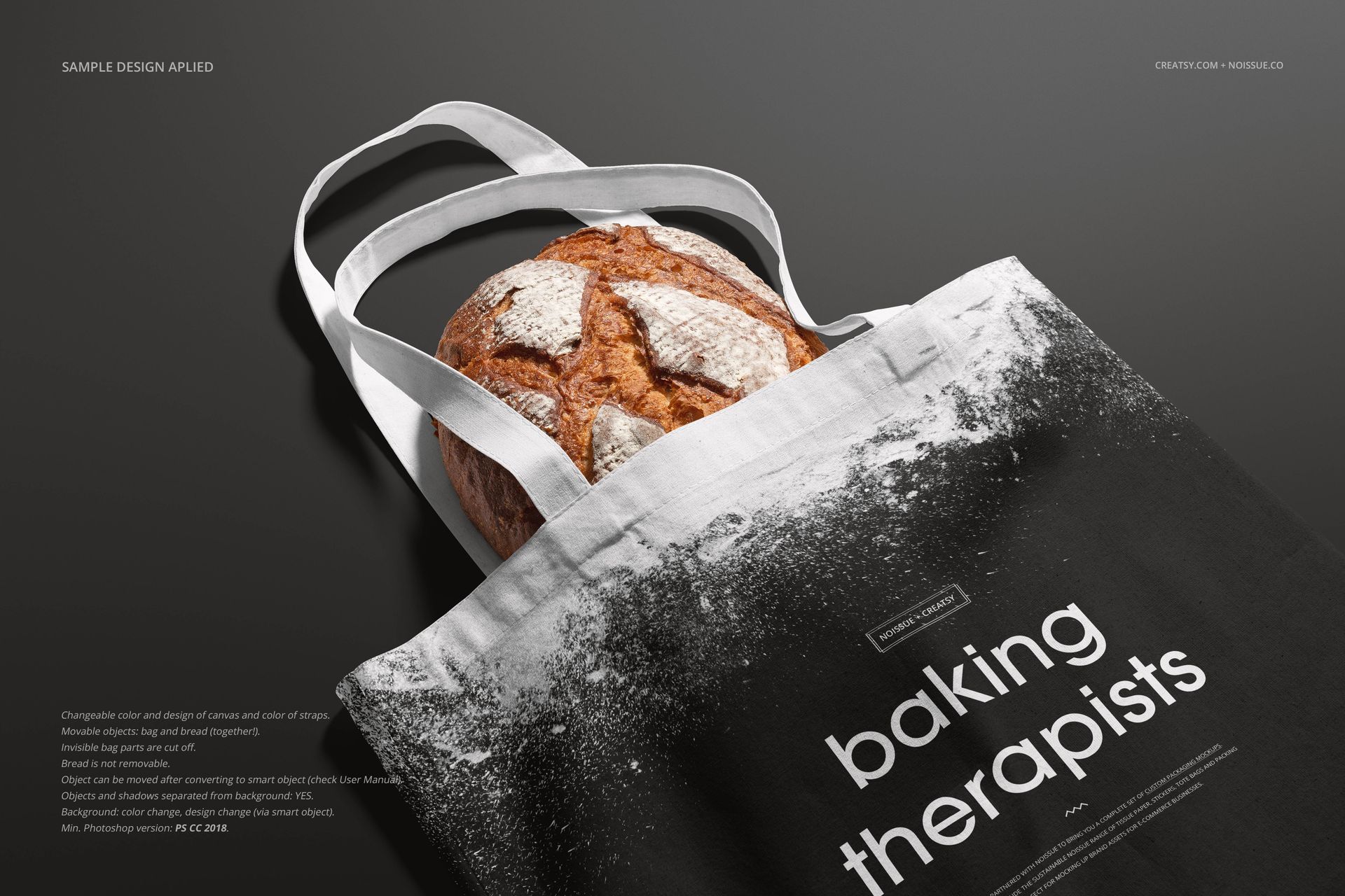 White tote bag mockup with black design and bold text, filled with rustic bread, displayed on a black background.