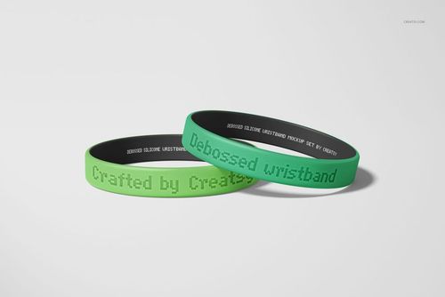 Debossed silicone wristbands mockup with green outer color and black inside, arranged in a clean composition.