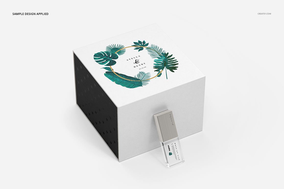 Acrylic USB drive slide box mockup featuring a botanical pattern on the lid and a clear USB drive in front.