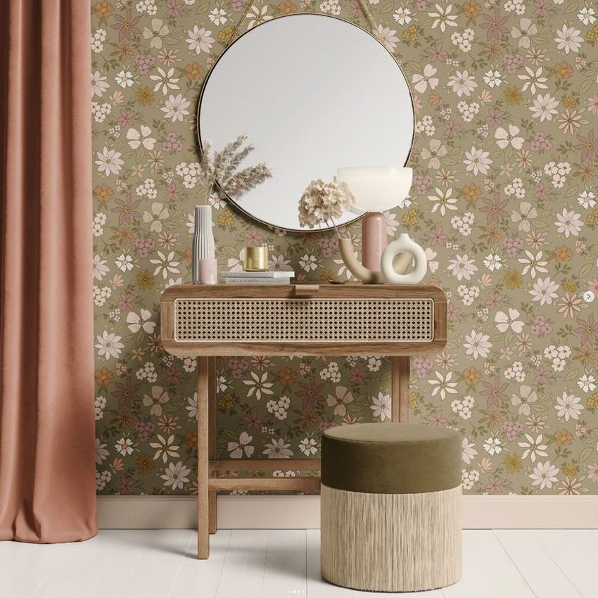 Dressing table mockup featuring a round mirror, floral wallpaper, and decorative vases on a wooden table with a cushioned stool.