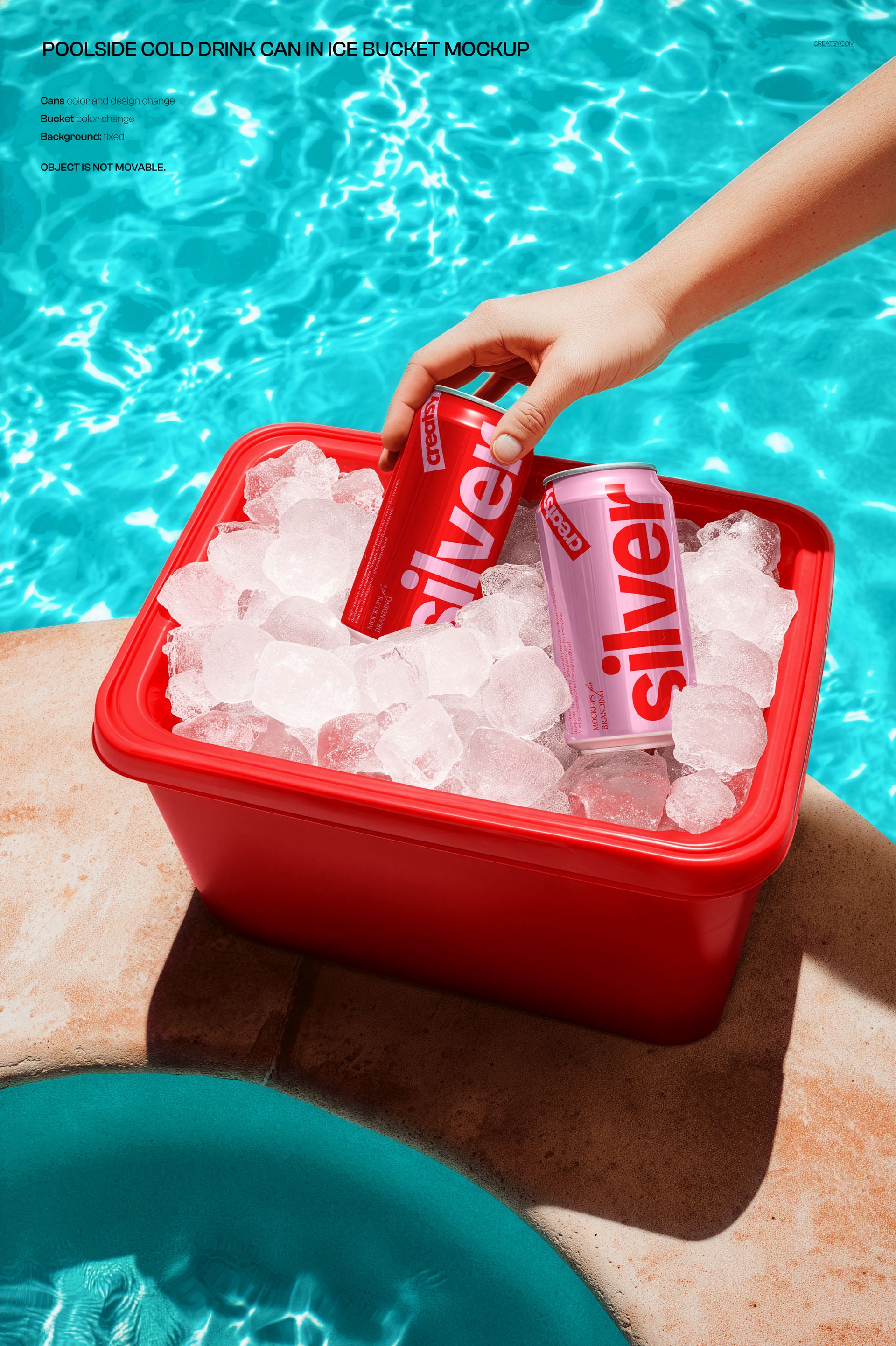 Red plastic ice bucket filled with ice cubes and two branded drink cans beside a swimming pool, hand holding one can.