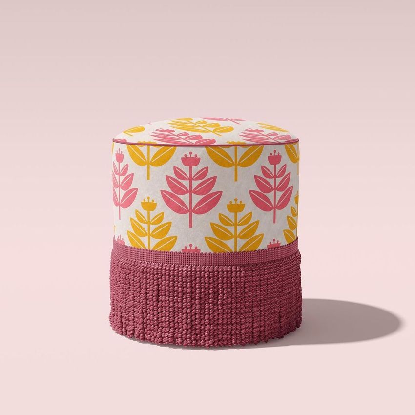 Fringed velvet footstool mockup featuring a retro floral pattern in pink and yellow on a light background, with a pink fringe base.