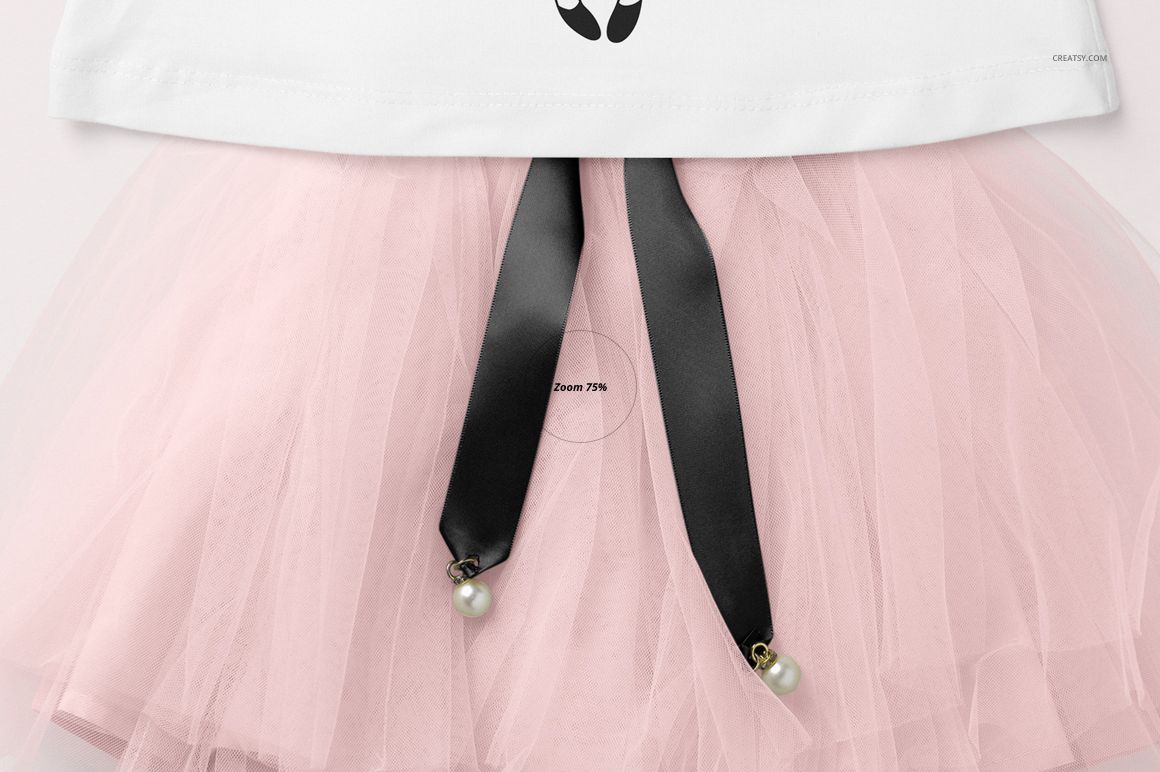 Front view of a girls mockup set featuring a white T-shirt and a light pink tulle skirt with black ribbon accents.