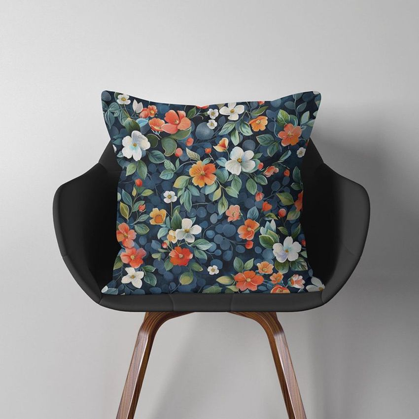 Throw pillow mockup featuring a floral-patterned pillow on a modern black chair against a plain light gray wall.