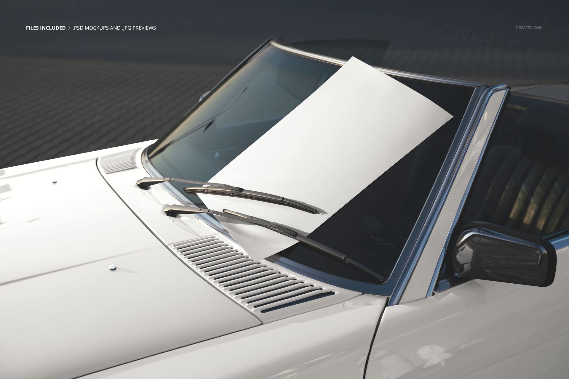 Large white poster mockup displayed on the windshield of a white car, viewed from an angled front perspective.