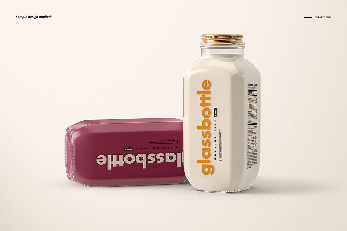 Glass bottle PSD mockup set showing one bottle standing with a white label and another bottle lying flat with a maroon label.