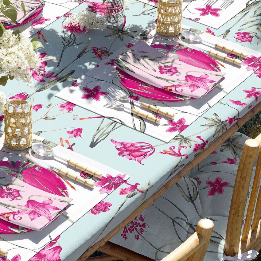 Tablecloth mockup featuring a garden table set with floral-patterned napkins, placemats, and matching tablecloth in pink and green.