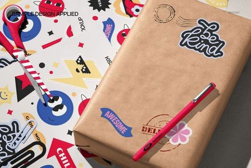 PSD mockup set showing vibrant stationery stickers and a kraft paper package in a well-lit, top-down view.
