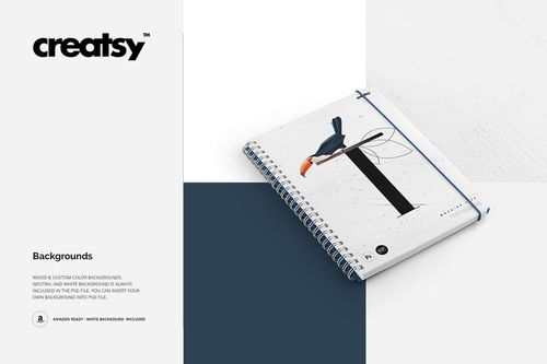 Notebook mockup featuring a white spiral notebook with minimalist design, displayed diagonally on color-blocked surfaces.