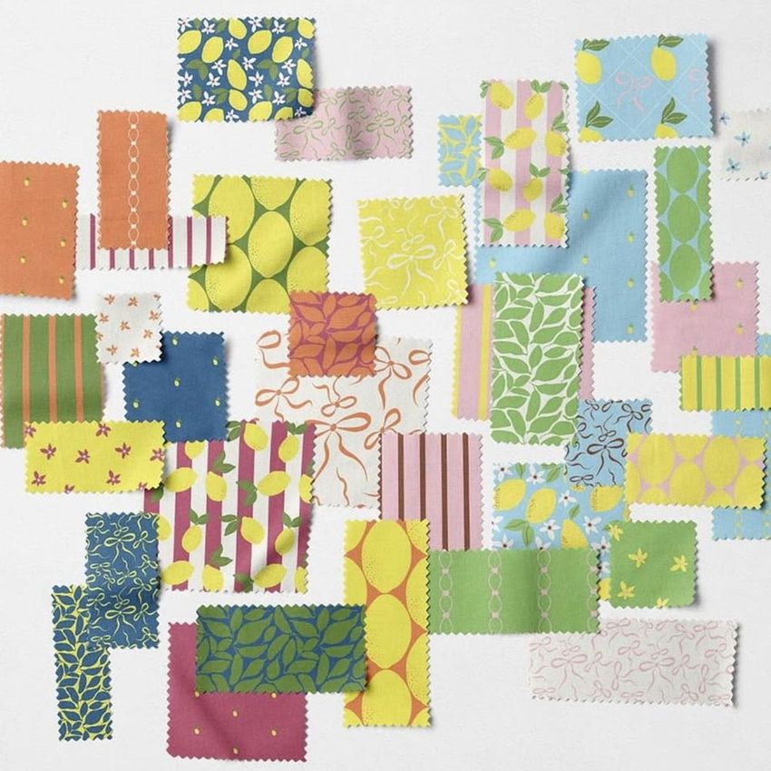 Fabric swatches mockup featuring rectangular pieces with various colorful patterns arranged on a light surface.