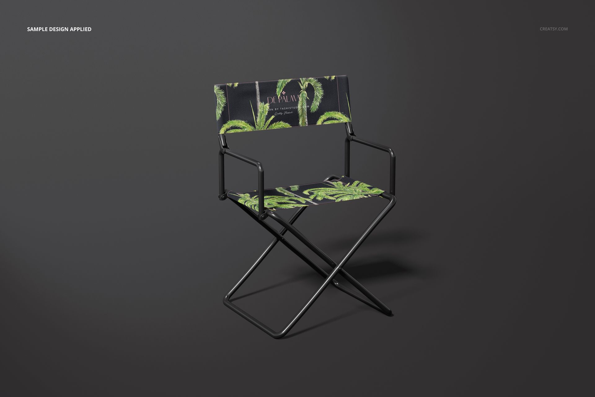 Front view of a director's chair mockup with a black seat and backrest featuring green palm leaf patterns on a dark background.