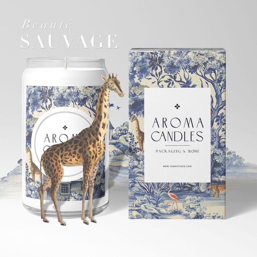 Can glass candle mockup set featuring a candle in a glass jar and a matching box with blue and white scenic patterns, a giraffe figurine in front.