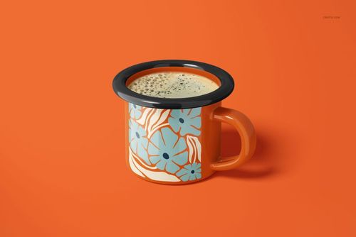 Orange enamel mug with blue floral pattern, filled with coffee, shown from a front angle on an orange background.