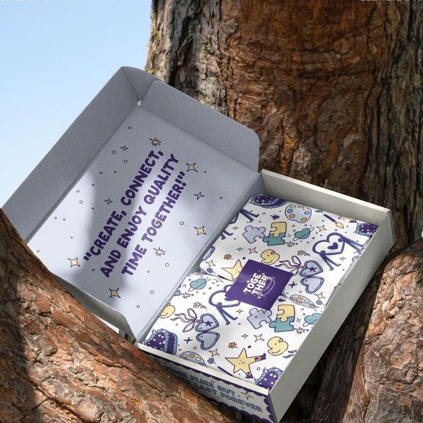 Mailing box mockup displayed open on a tree trunk, featuring playful illustrated patterns and a visible text message inside.