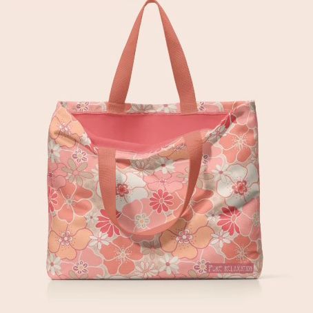 Large poly canvas tote bag mockup featuring a pink and peach floral pattern, photographed upright on a light beige background.