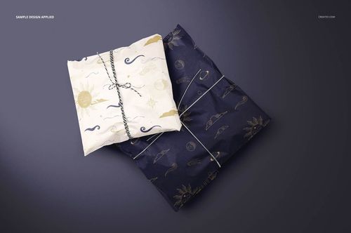 PSD mockup featuring two gift packages wrapped in contrasting tissue paper with sun and moon motifs, displayed on a flat surface.