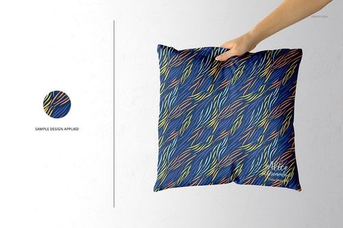 PSD mockup of a throw pillow with a vibrant abstract line design on blue fabric, shown against a plain background.