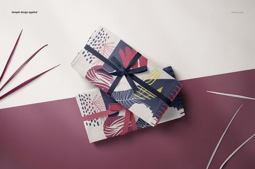 Two folded fabric pieces featuring bold graphic designs in navy, pink, and yellow, arranged on a mockup background.