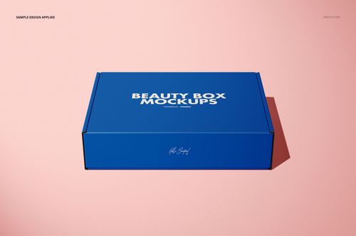 Rectangular blue mailing box mockup displayed on a light pink surface, front view with lid closed.