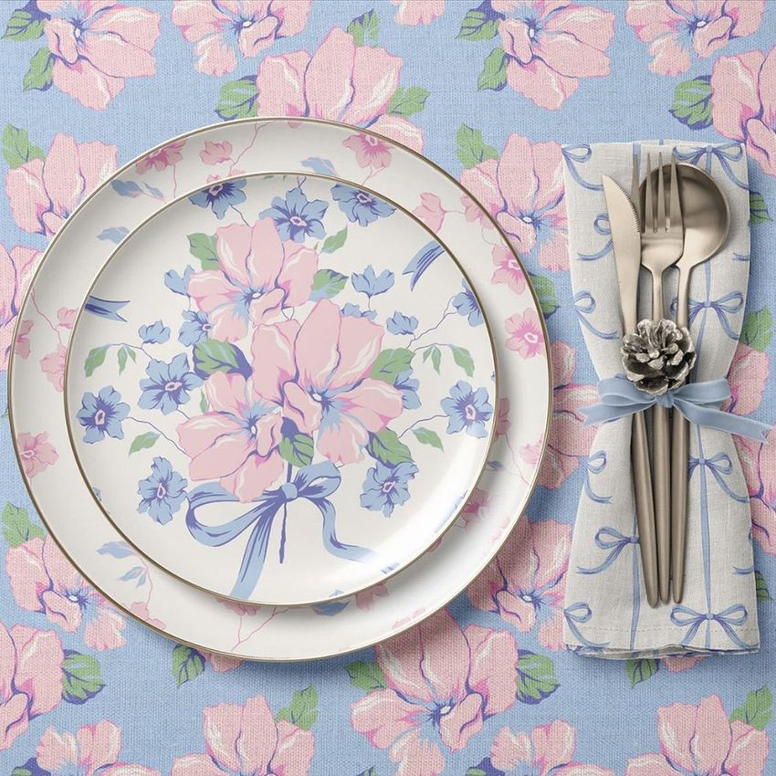 Plate, napkin, and tablecloth mockup featuring a floral pattern in pastel pink, blue, and green with a top-down view.