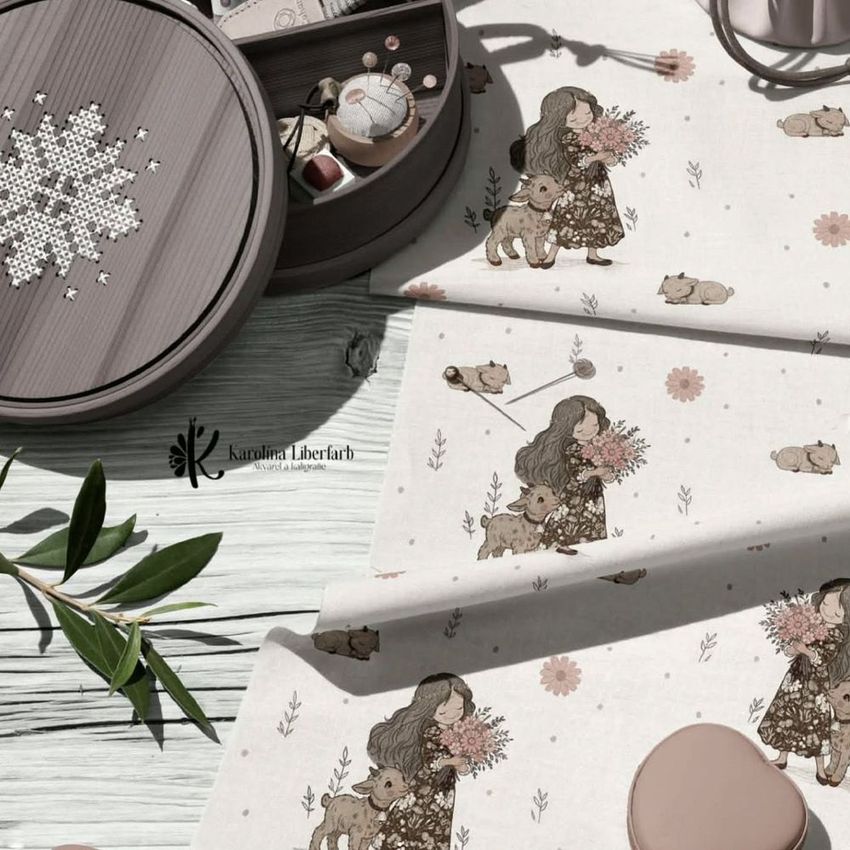 Cotton fabric and embroidery kit mockup featuring illustrated fabric with a woman and child, embroidery hoop, and sewing tools on a wooden surface.