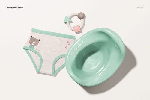 Toddler training pants mockup set featuring white pants with mint trim and bear design, mint potty, and teething toy, top view.