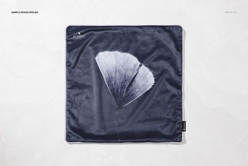 Square velvet pillow mockup featuring a navy blue color and a white botanical pattern, viewed from above.