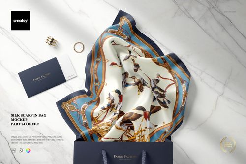 Fashion accessory mockup with a patterned silk scarf in blue, cream, and brown, presented in a gift bag with jewelry and envelopes.