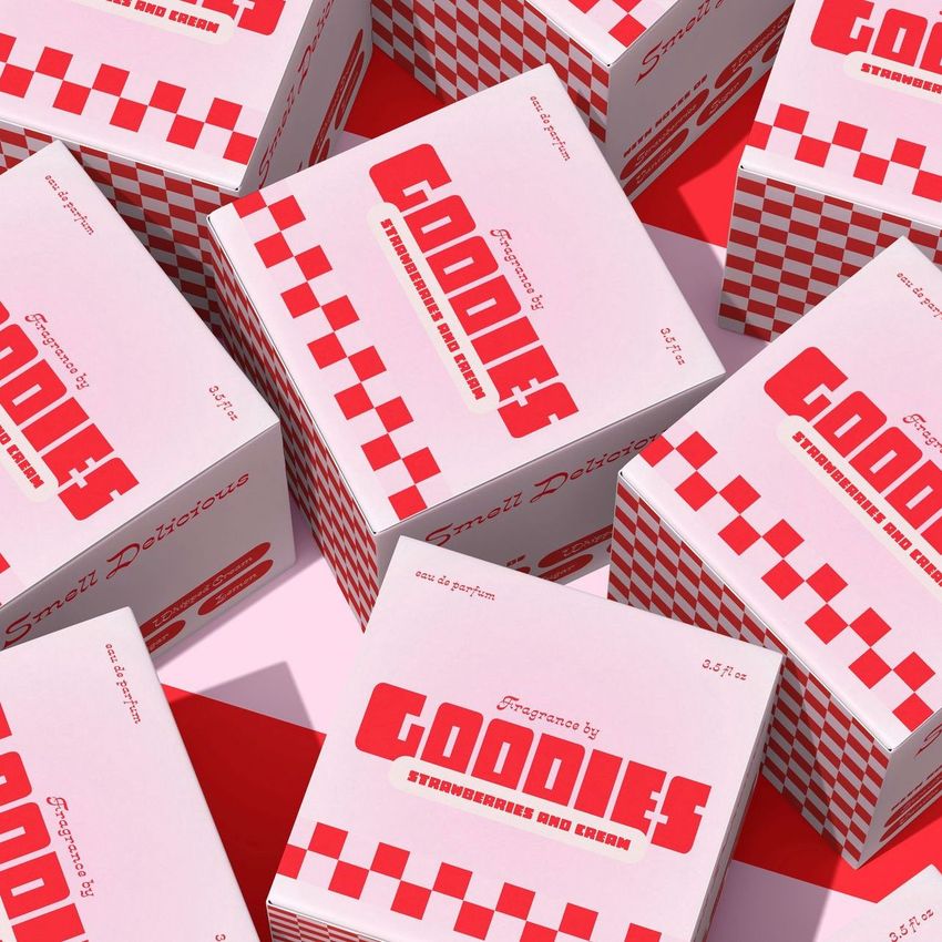 Square box mockup featuring several pink and red packaging boxes with bold text and checkerboard patterns, viewed from above.